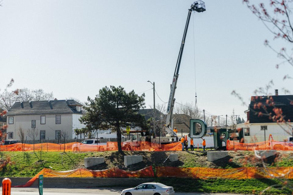 Contractors place the "D" in Detroit along the side of eastbound I-94 on April 9, 2024.