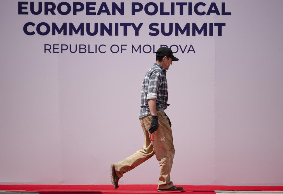 A man walks by banners during preparations at the Castel Mimi in Bulboaca, Moldova, Wednesday, May 31, 2023. Moldova will host the Meeting of the European Political Community on June 1, 2023. Preparations for a major summit of European leaders were still underway in Moldova on Wednesday, a sign of the Eastern European country’s ambitions to draw closer to the West and break with its Russian-dominated past amid the war in neighboring Ukraine.. (AP Photo/Andreea Alexandru)