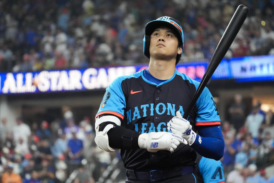 National League's Shohei Ohtani, of the Los Angeles Dodgers, warms up during the first inning of the MLB All-Star baseball game, Tuesday, July 16, 2024, in Arlington, Texas. (AP Photo/LM Otero)