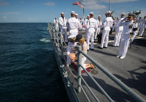 US Navy Lieutenant Commander Paul Nagy, USS Philippine Sea, and Carol Armstrong, wife of Neil Armstrong, commit the cremains of Neil Armstrong to sea during a burial at sea service held onboard the USS Philippine Sea (CG 58), Friday, Sept. 14,