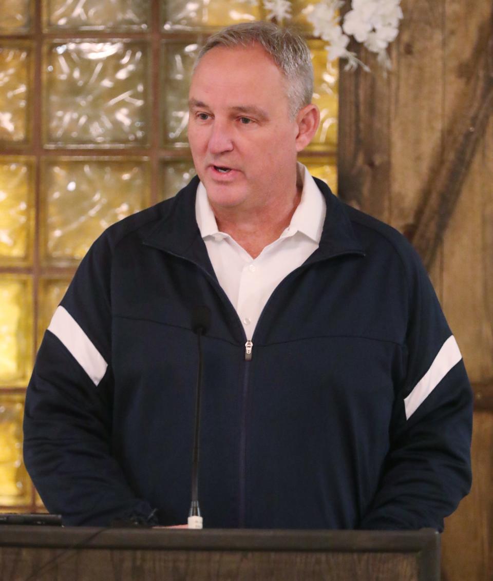 Ellet boys basketball coach Mark Fisher speaks at the Akron Public Schools City Series Basketball Media Day at Guy's Party Center in Akron on Tuesday.