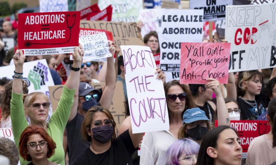 People gather in front of the Georgia State Capital in Atlanta to protest.