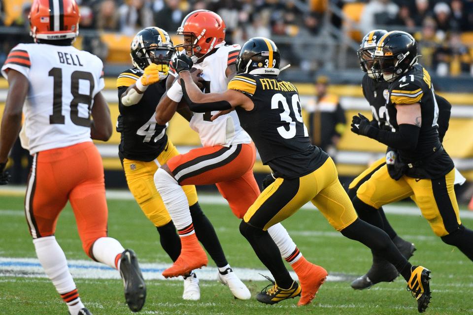 Cleveland Browns quarterback Deshaun Watson (4) is tackled by Pittsburgh Steelers safety Minkah Fitzpatrick (39) and cornerback James Pierre (42) during the second half of an NFL football game in Pittsburgh, Sunday, Jan. 8, 2023. (AP Photo/Don Wright)