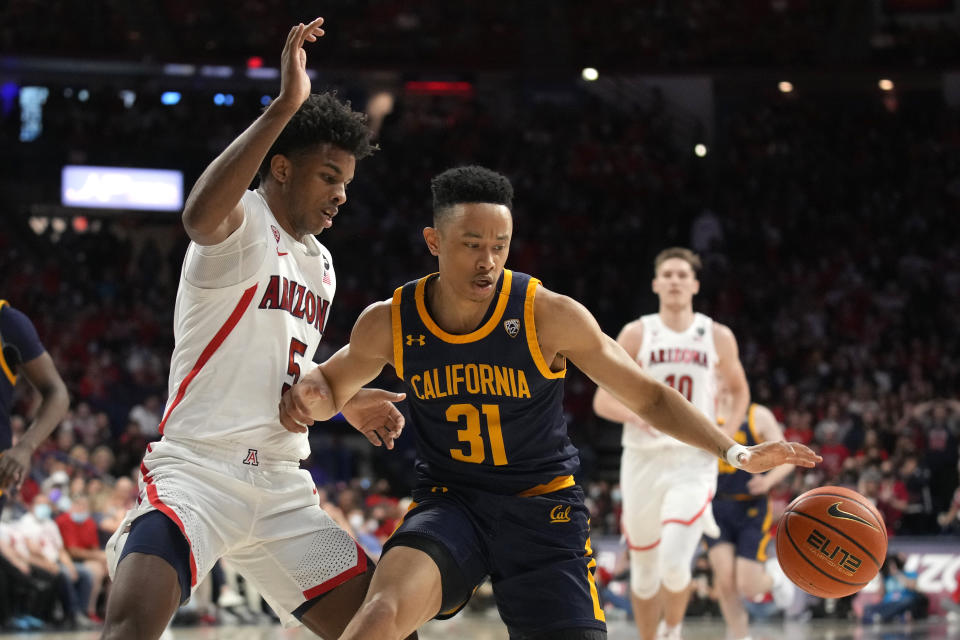 California guard Jordan Shepherd (31) gets pressured by Arizona guard Justin Kier during the first half of an NCAA college basketball game, Saturday, March 5, 2022, in Tucson, Ariz. (AP Photo/Rick Scuteri)