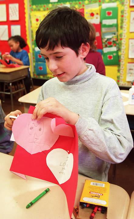 Third grader Scott Pullen puts the finishing touch on his Valentine to his mom, at Curley Elementary School in Boston in 1999. (Tom Herde/The Boston Globe/Getty Images)