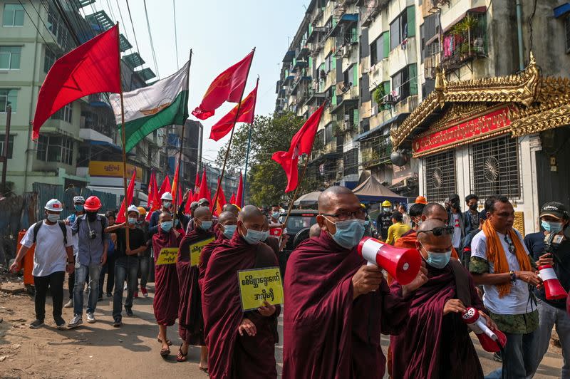 Buddhist monks and demonstrators rally against the military coup and to show their support to local residents after riot police officers used teargas to disperse a crowd that held a protest the night before in Yangon's Tamwe neighborhood