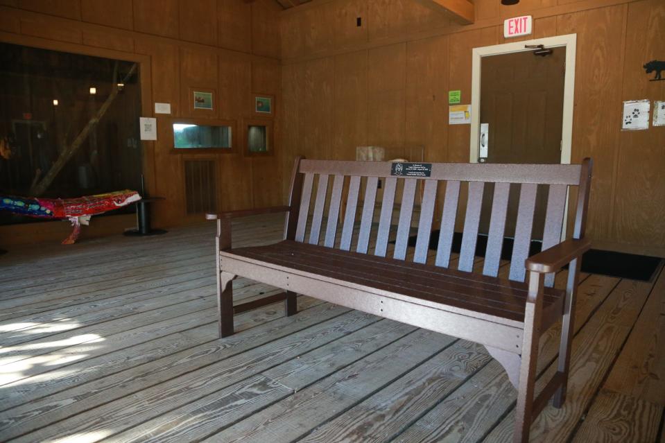 A bench in Logan McCay's memory sits in the wolf barn at Oatland Island.