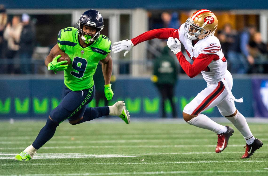 Seattle Seahawks running back Kenneth Walker III (9) runs down the field with the ball as San Francisco 49ers cornerback Deommodore Lenoir (38) tries to guard him in the fourth quarter of an NFL game at Lumen Field in Seattle Wash. on Dec. 15, 2022.