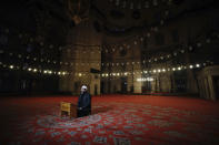 An imam recites Qoran during the Eid al-Fitr prayer amid concerns of the coronavirus outbreak at historical Suleymaniye Mosque, in Istanbul, early Sunday, May 24, 2020. Muslims in the world are marking a muted and gloomy religious festival of Eid al-Fitr, the end of the fasting month of Ramadan _ a usually joyous three-day celebration that has been significantly toned down due to the new coronavirus outbreak. (AP Photo/Emrah Gurel)