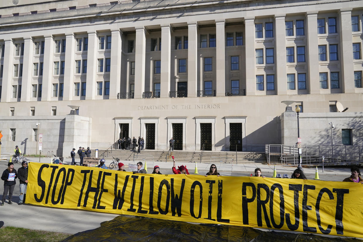 Demonstraters protest against the Biden administration's approval of the Willow oil-drilling project before a scheduled speech by Biden at the Department of the Interior in Washington, Tuesday, March 21, 2023. (AP Photo/Patrick Semansky)