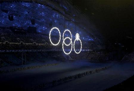 Four out of five of the Olympic rings are seen lit up during the opening ceremony of the 2014 Sochi Winter Olympics, February 7, 2014. REUTERS/Mark Blinch