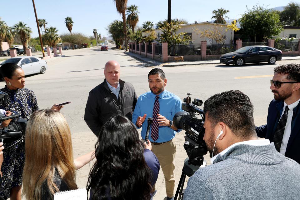 White House Senior Advisor and Infrastructure Coordinator Mitch Landrieu, left, listens to Congressman Raul Ruiz speak to members of the media about the infrastructure needs of Oasis Mobile Home Park and the surrounding area in Thermal, Calif., on Tuesday, April 4, 2023. Landrieu and Ruiz then met with a family living at the mobile home park. 