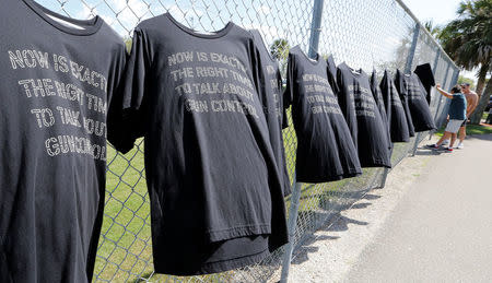 T-shirts hang on a fence near Marjory Stoneman Douglas High School in Parkland, Florida, U.S., February 23, 2018. REUTERS/Joe Skipper