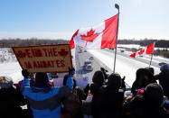 <p>People gather on an overpass to support truckers arriving in a convoy to protest coronavirus disease (COVID-19) vaccine mandates for cross-border truck drivers, in Ottawa, Ontario, Canada, January 28, 2022. REUTERS/Patrick Doyle</p> 