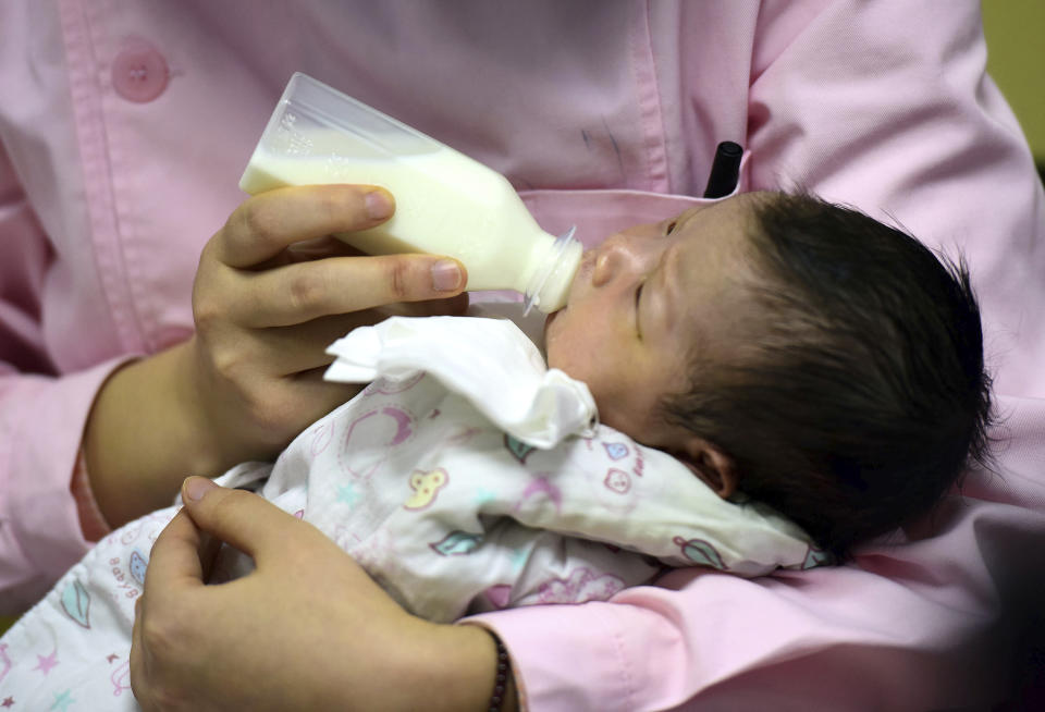 In this Jan. 19, 2019, photo, a nurse feeds a newborn baby at a hospital in Fuyang in central China's Anhui province. Facing a future demographic crisis and aging society, China’s leaders are desperate to encourage higher fertility rates. But the country’s bureaucrats don’t seem to have gotten the message, fining a couple in a recent widely publicized case for having a third child against the strict letter of the law. That has sparked outrage among the public, who are venting their anger at officials who long persecuted couples for violating the now-scrapped “one-child policy.”(Chinatopix via AP)