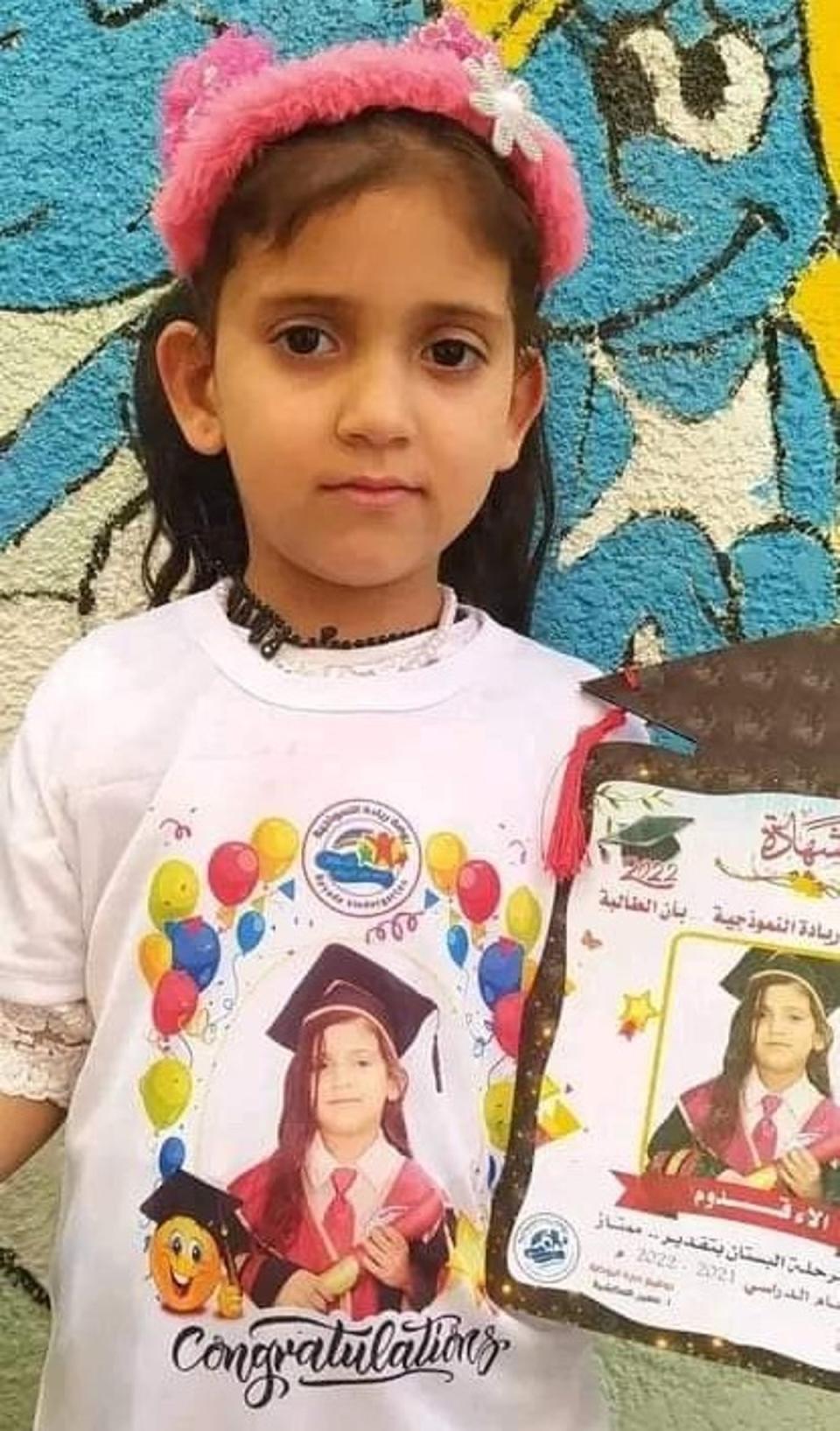 Alaa, 5, is pictured holding her kindergarten diploma (Family handout)