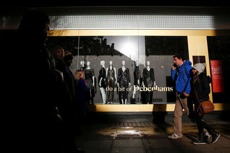 FILE PHOTO: Shoppers walk past a window display at the Debenhams department store on Oxford Street in London, Britain December 17, 2018. REUTERS/Simon Dawson/File Photo