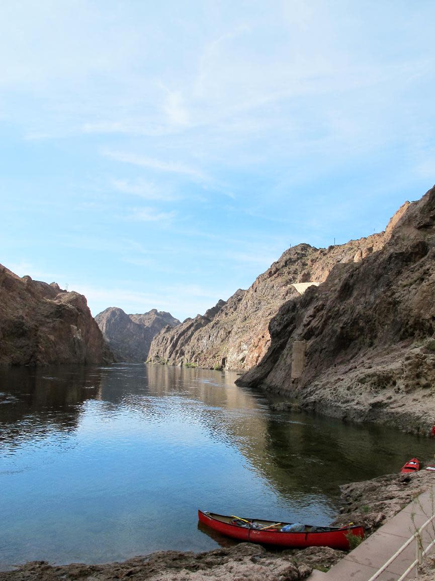 This April 13, 2013 photo shows the Colorado River snaking through the Black Canyon near Boulder City, Nev. Watercraft must be transported through a federal security zone near the Hoover Dam by an authorized livery service, whether you bring your own gear, rent watercraft or sign up for a guided trip. But some of the guide companies will pick you up at your hotel on the Las Vegas Strip some 30 miles away first thing in the morning and have you in the water before lunch. (AP Photo/Karen Schwartz)