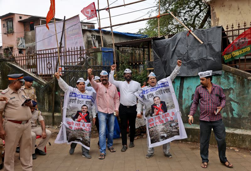 People shout slogans as they wear banners during a protest against the redevelopment of Dharavi by the Adani Group in Mumbai