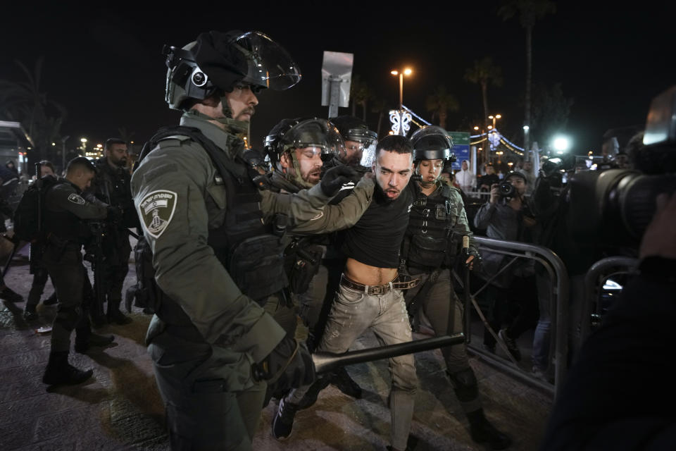 Israeli border police officers detain a protester during clashes between Israeli security forces and Palestinians next to Damascus Gate, outside the Old City of Jerusalem, during the Muslim holy month of Ramadan, Monday, April 4, 2022. (AP Photo/Mahmoud Illean)