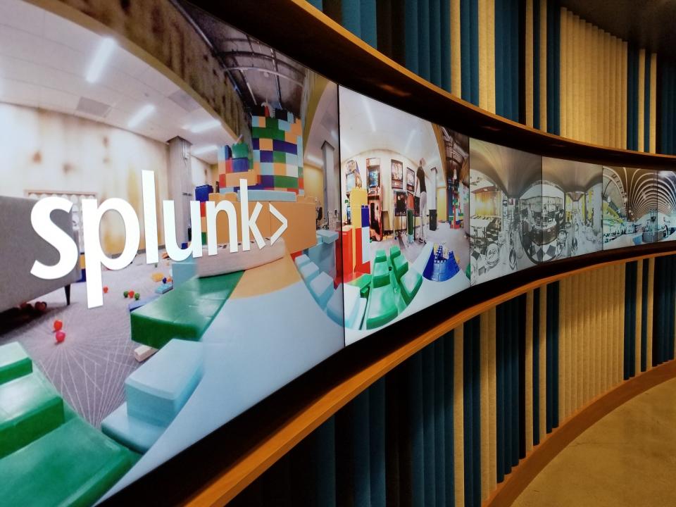 Panoramic display of flat screen TVs showing Splunk's logo and headquarters office.