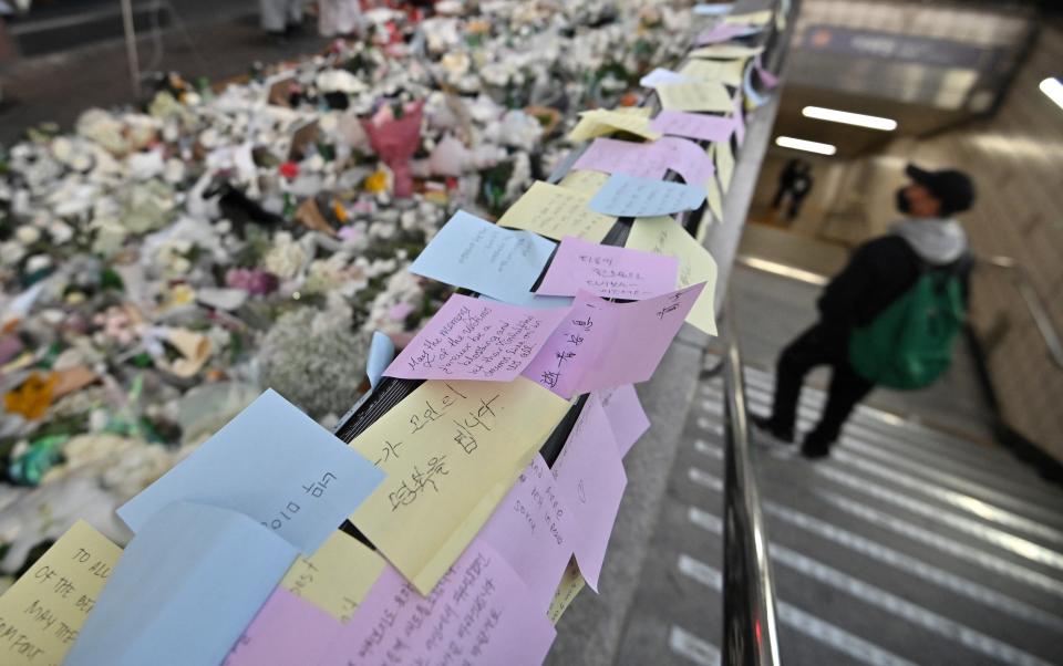 Messages from mourners are pictured at a makeshift memorial for the victims of the deadly Halloween crowd surge, outside a subway station in the district of Itaewon in Seoul on 1 November 2022 (AFP via Getty Images)