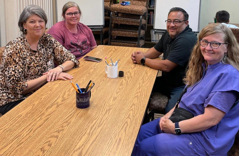 From left: Jennifer Wilkins, Tabitha Sarabia, Greg Sarabia, and Dr. Frannie Koe make plans at a monthly Equitable Neighborhoods Initiative meeting on June 19, 2023, at the Collinsville Public Library in Collinsville, Alabama.