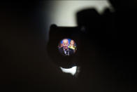 FILE - President Joe Biden is seen through a TV camera viewfinder as he speaks during a political rally at the Philadelphia Convention Center in Philadelphia, Saturday, June 17, 2023. “It’s really hard to tell the story of how generative AI is a net positive when so many bad actors – whether that’s robocalls, fake images or false video clips – are using the bad set of AI against us,” said a Democratic strategist close to the Biden campaign who would only discuss what was described as a sensitive topic if granted anonymity. (AP Photo/Joe Lamberti, File)