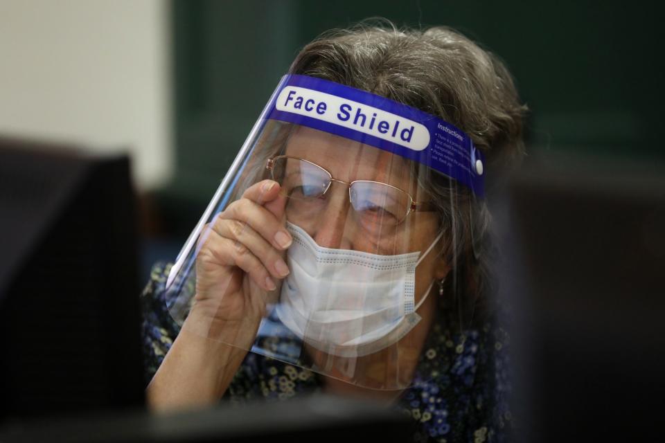 First-grade teacher Carol Kent helps Hunter Roe, 6, not shown, with an assessment test.