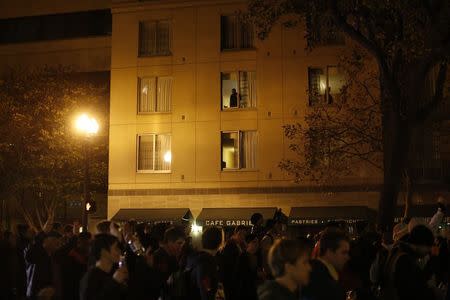 Residents watch from their windows as protesters march on Broadway Street during a demonstration in Oakland, California November 26, 2014, following a grand jury's decision in the shooting of an unarmed black teenager in Ferguson, Missouri. REUTERS/Stephen Lam