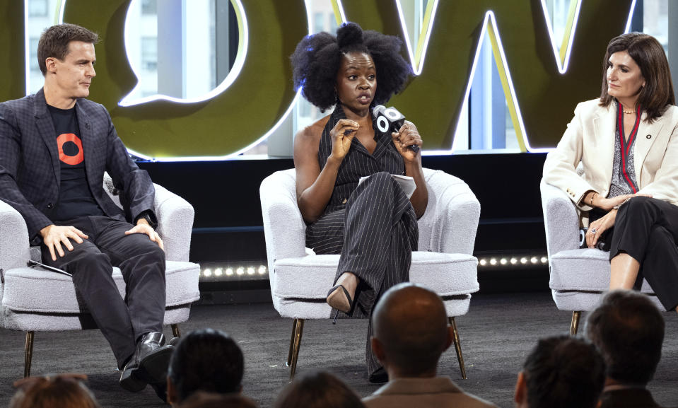 Hugh Evans, CEO of Global Citizen, left, listens as Actor Danai Gurira, center, addresses attendees of the Global Citizen Now conference, Wednesday, May 1, 2024, in New York. Fran Katsoudas is right. (AP Photo/Craig Ruttle)