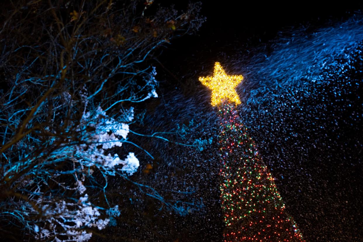 It's a white Christmas in Ridgeland, Miss., during the city tree lighting ceremony Thursday, Dec. 2, 2021. Snowflakes from snow machines floated down as carolers sang, children got their photos with Santa and people felt spirit of the season