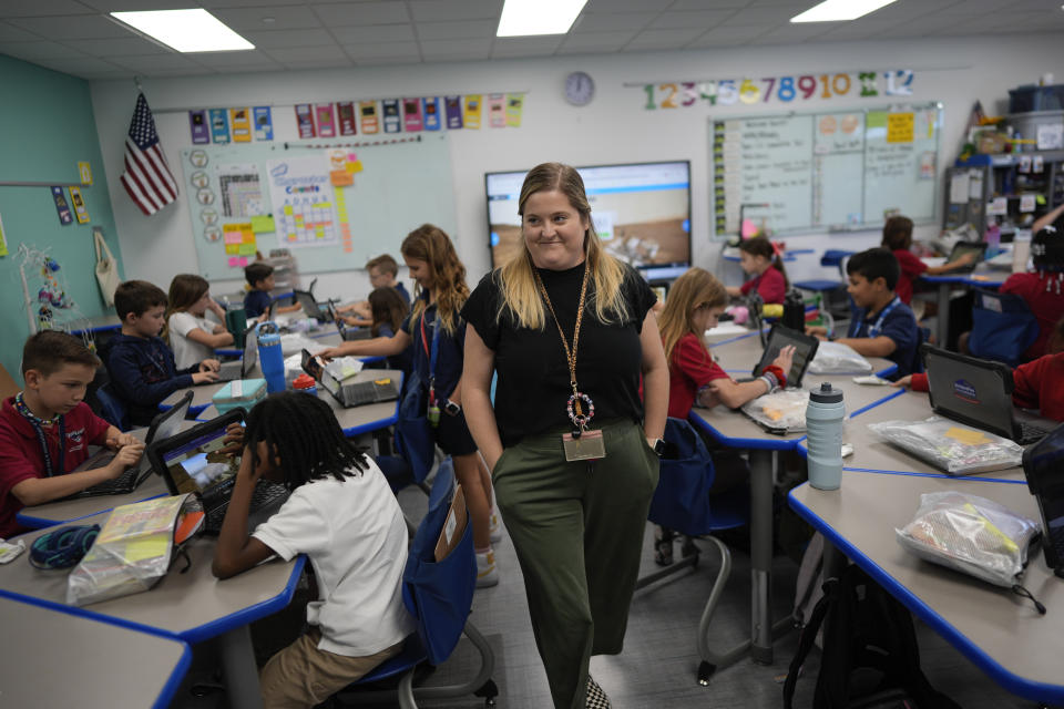 Third grade teacher Megan Foster walks through her classroom as students take a break from a reading lesson to explore a computer animation of the planet Mars, at A.D. Henderson School in Boca Raton, Fla., Tuesday, April 16, 2024. When teachers at the K-8 public school, one of the top-performing schools in Florida, are asked how they succeed, one answer is universal: They have autonomy. (AP Photo/Rebecca Blackwell)