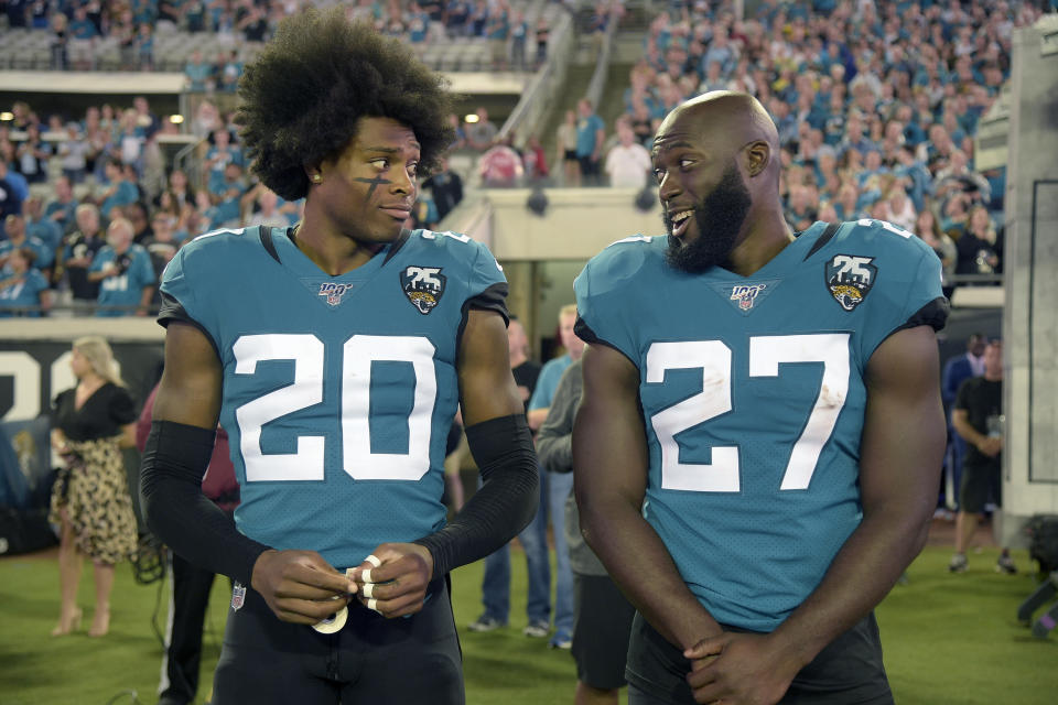 Jacksonville Jaguars cornerback Jalen Ramsey (20) talks to running back Leonard Fournette (27) before an NFL football game against the Tennessee Titans Thursday, Sept. 19, 2019, in Jacksonville, Fla. (AP Photo/Phelan M. Ebenhack)