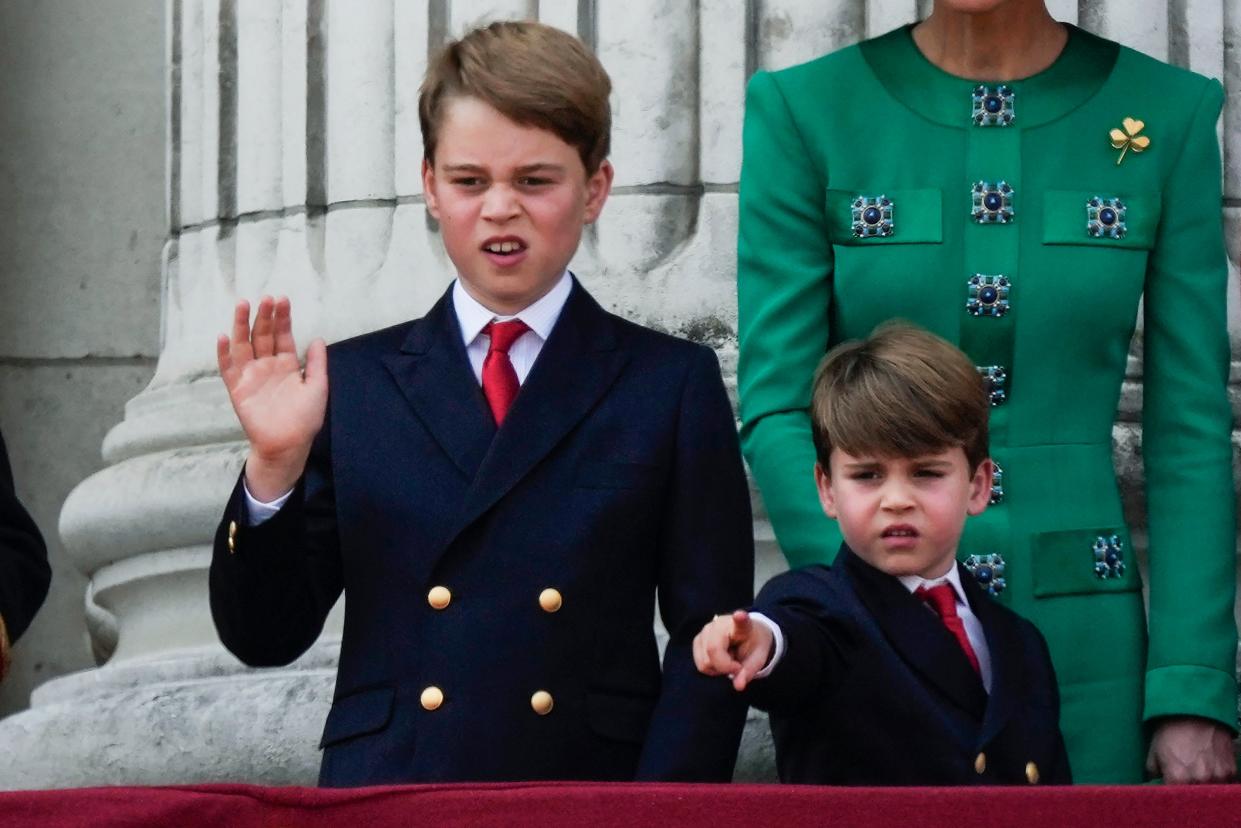 Prince George, left, and Prince Louis, greet the crowd from the balcony of Buckingham Palace (AP)