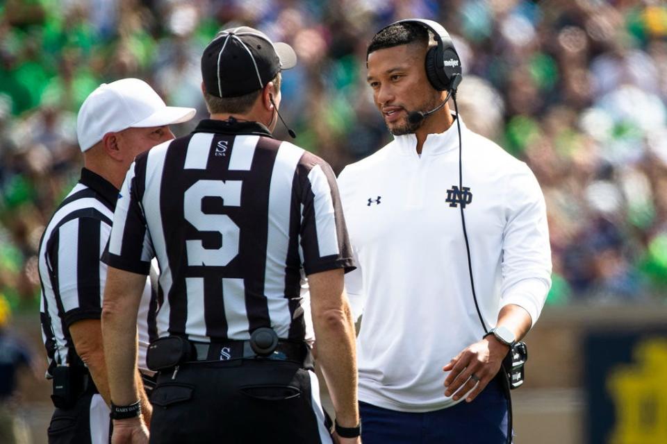 Notre Dame head coach Marcus Freeman talks with officials during the first half of an NCAA college football game against Central Michigan on Saturday, Sept. 16, 2023, in South Bend, Ind. (AP Photo/Michael Caterina)