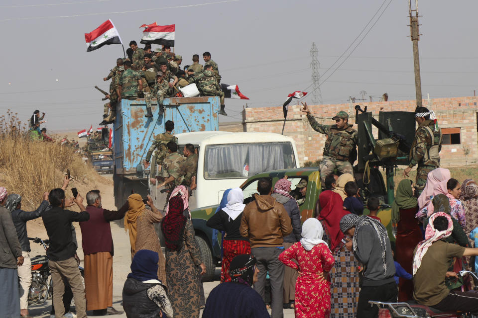 Syrian government forces reinforcements arrive near the city of Ras al-Ayn, in the north of Syria, Saturday, Oct. 26, 2019. (AP Photo)