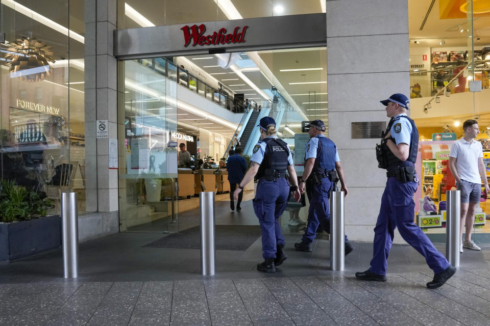 Police officers walk into the Westfield shopping mall at Bondi Junction in Sydney, Friday, April 19, 2024. The Sydney shopping mall reopened for business on Friday for the first time since it became the scene of a mass stabbing in which six people died on Saturday, April 13. (AP Photo/Mark Baker)