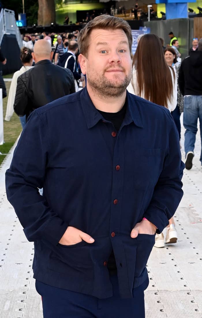 James with his hands in his jacket pockets as he's photographed at an event