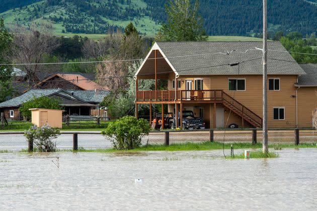 Floodwaters course through Livingston, Montana, on Tuesday. The Yellowstone River hit a record high flow from rain and snow melt from the mountains in and around Yellowstone National Park. (Photo: William Campbell via Getty Images)