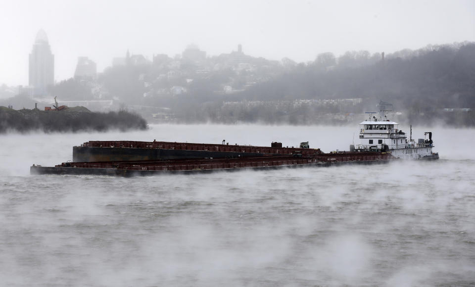 A barge moves up a steamy Ohio River, Monday, Jan. 6, 2014, past downtown Cincinnati. Temperatures in the area dipped below zero. Frigid, dense air swirled across much of the U.S. on Monday, (AP Photo/Al Behrman)
