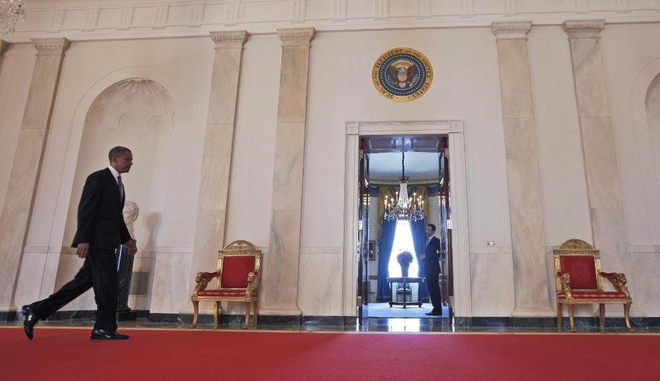 President Barack Obama walks back to the Blue Room of the White House in Washington, Thursday, June 28, 2012, after the Supreme Court ruled on his health care legislation. (AP Photo/Pablo Martinez Monsivais/pool)