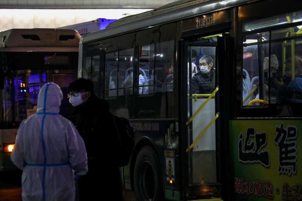 In this Wednesday, Feb. 5, 2020, photo, patients who diagnosed with the coronaviruses arrive at a temporary hospital which transformed from an exhibition center in Wuhan in central China's Hubei province. Ten more people were sickened with a new virus aboard one of two quarantined cruise ships with some 5,400 passengers and crew aboard, health officials in Japan said Thursday, as China reported 73 more deaths and announced that the first group of patients were expected to start taking a new antiviral drug. (Chinatopix via AP)