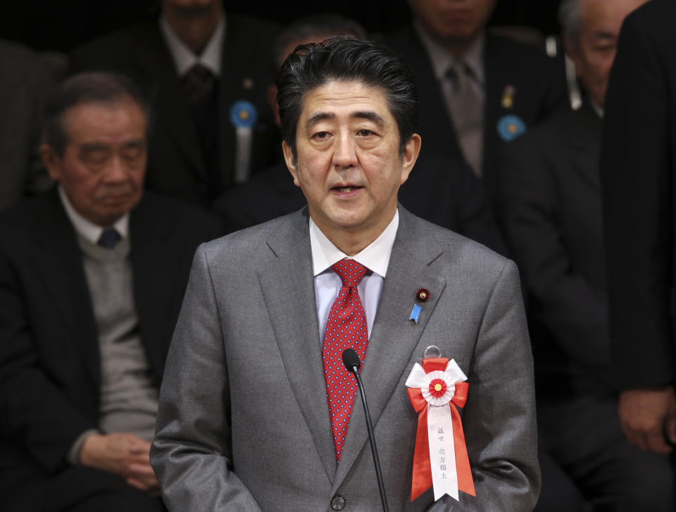 Japanese Prime Minister Shinzo Abe delivers his speech during a national rally to demand the return of Russian-held four islands floating off the northernmost main island of Hokkaido, in Tokyo, Friday, Feb. 7, 2014, Japan has designated Feb. 7 as "Northern Territories Day. Abe and his Chinese counterpart appear not to be bothered by the international ruckus over Russia's law restricting gay rights. Unlike President Barack Obama, who pointedly declined to attend the Winter Olympics, the leaders of the world's second and third largest economies — where gay rights are not a hot-button political issue — are going to Sochi. (AP Photo/Koji Sasahara)