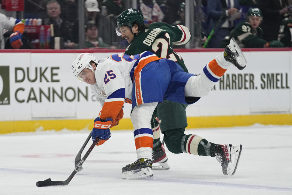 New York Islanders defenseman Sebastian Aho, front, battles for the puck against Minnesota Wild right wing Brandon Duhaime during the first period of an NHL hockey game Tuesday, Feb. 28, 2023, in St. Paul, Minn. (AP Photo/Abbie Parr)