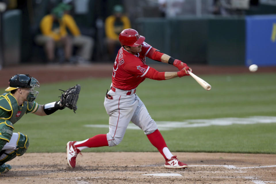 Los Angeles Angels' David Fletcher hits an RBI single nexxt to Oakland Athletics' Sean Murphy during the fifth inning of a baseball game in Oakland, Calif., Tuesday, June 15, 2021. (AP Photo/Jed Jacobsohn)