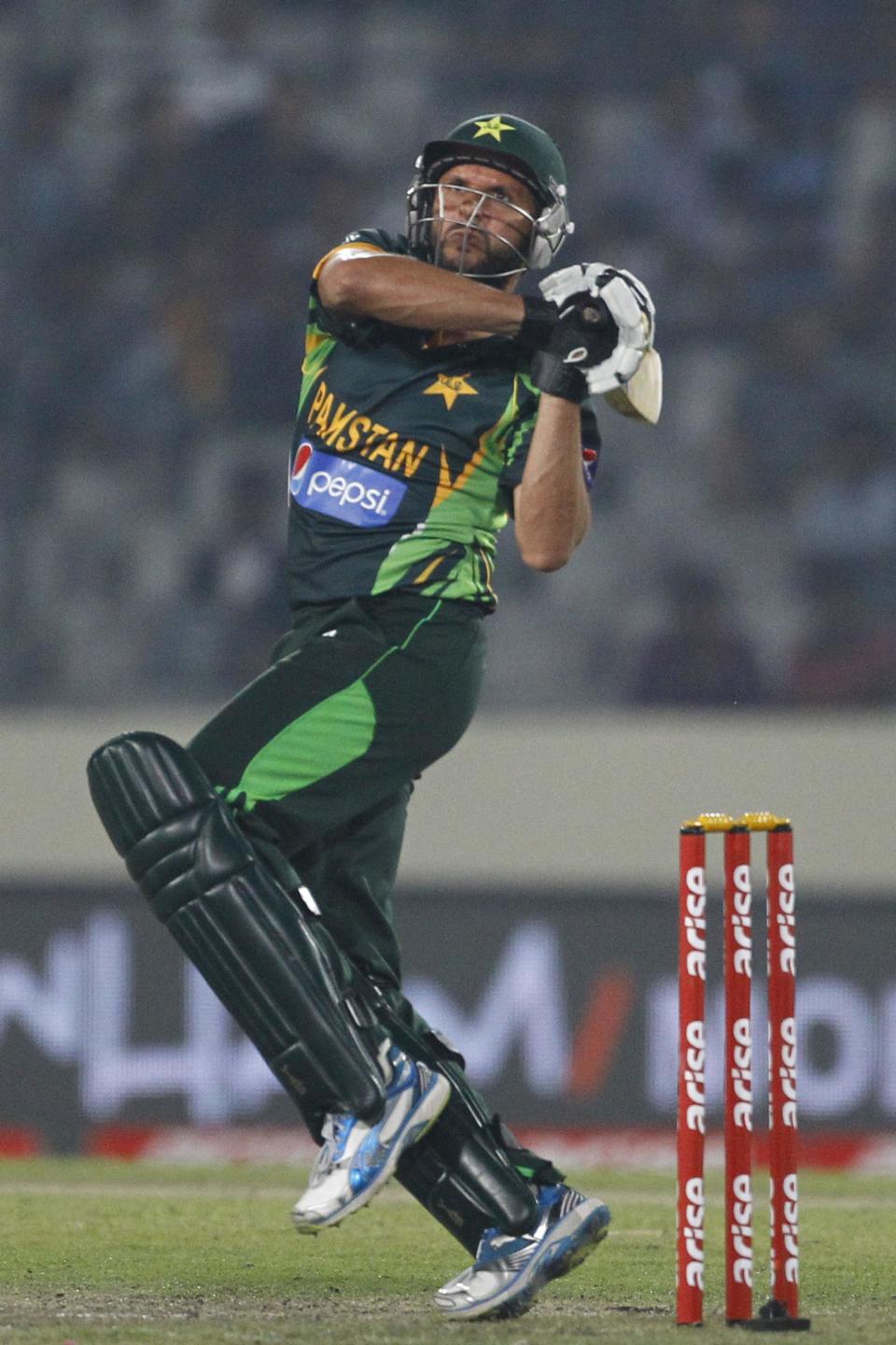 Pakistan’s Shahid Afridi, plays a shot during their match against Bangladesh in the Asia Cup one-day international cricket tournament in Dhaka, Bangladesh, Tuesday, March 4, 2014. (AP Photo/A.M. Ahad)