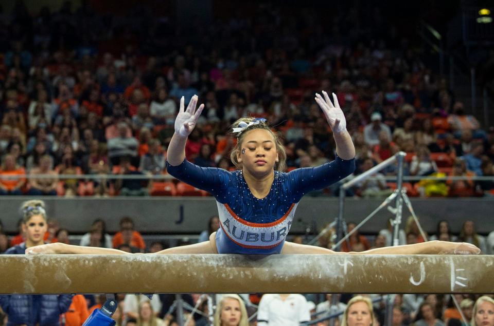 Auburn's Suni Lee performs on the beam as Auburn Tigers gymnastics takes on Florida Gators at Neville Arena in Auburn, Ala., on Saturday, March 5, 2022. Auburn Tigers and Florida Gators ended in a tie at 198.575.