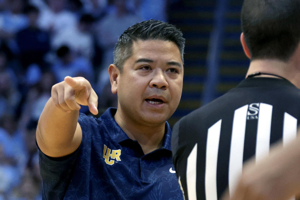 UC Riverside head coach Mike Magpayo, left, discuses a call with an official during the first half of an NCAA college basketball game against North Carolina, Friday, Nov. 17, 2023, in Chapel Hill, N.C. (AP Photo/Chris Seward)