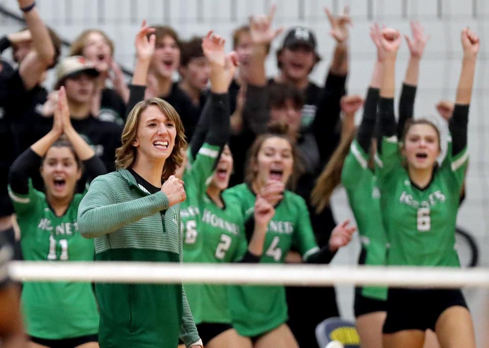 Highland coach Laura Merk celebrates a point during the second set of a Division I regional semifinal against Amherst on Nov. 3, 2022, in Norwalk.